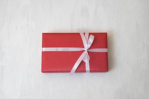 Red gift box with white ribbon isolated on white background. Stock Photos
