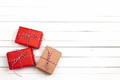 Red gift boxes and copy space on white wooden background. Stock Photos