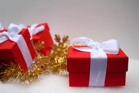 Red gift boxes and decorated New Year on the background. Stock Photos