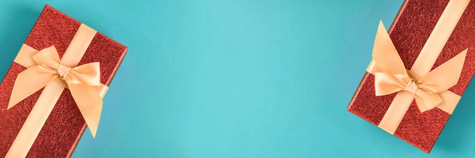 A red gift boxes on the blue background. Stock Photos