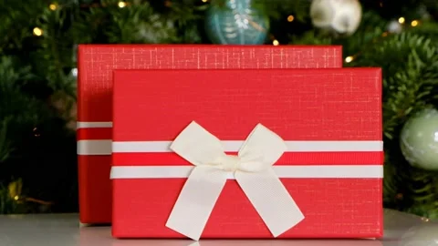 Red gift boxes on Christmas tree background. Stock Footage 184786548