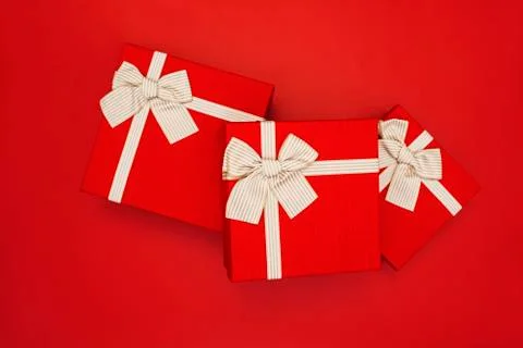 Red gift boxes on red background. Gift boxes tied with gold ribbon and bows o Stock Photos