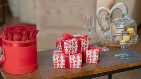 Red gift boxes with roses and champagne setup Stock Photos