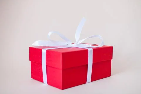 Red gift boxes of various sizes tied with a white satin ribbon Stock Photos