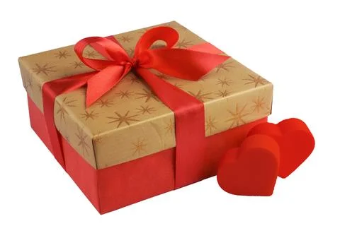 Red gift or present box with golden colored top, red ribbon bow and two hearts Stock Photos