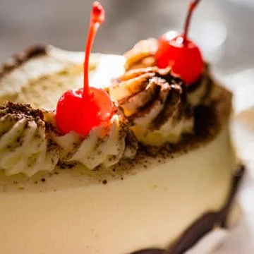 Red glace cherry on top of cake, macro, closeup, selective focus. Stock Photos
