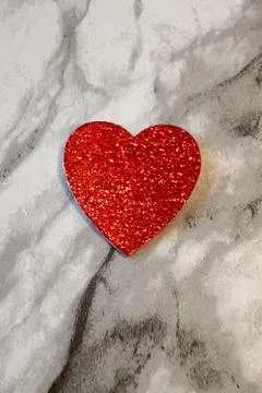 Red glitter heart on marble background Stock Photos