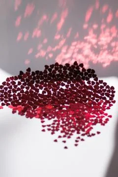 Red glitter hearts on white background. Stock Photos