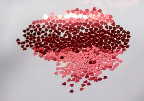 Red glitter hearts on white background. Stock Photos