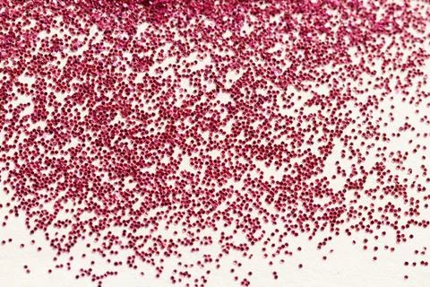 Red glitter on light background - macro photo Stock Photos
