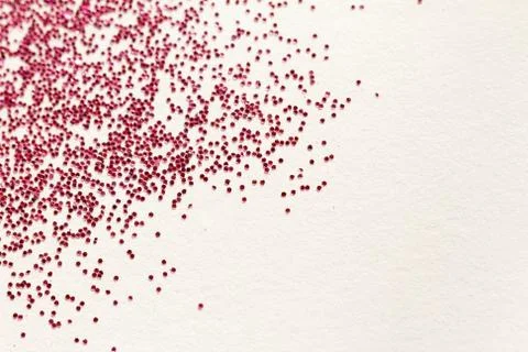 Red glitter on light background - macro photo Foto stock
