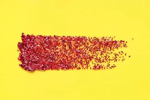Red glitter stroke on yellow background Stock Photos