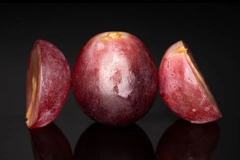 Red globe grape on black glass Stock Photos