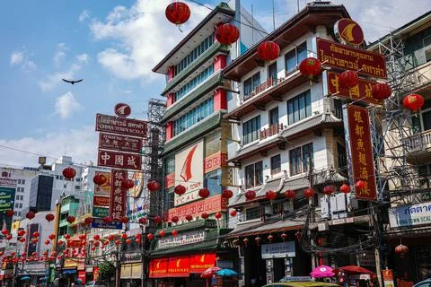 Red globe lanterns hanging on wire with background of buildings in Chinatown. Stock Photos