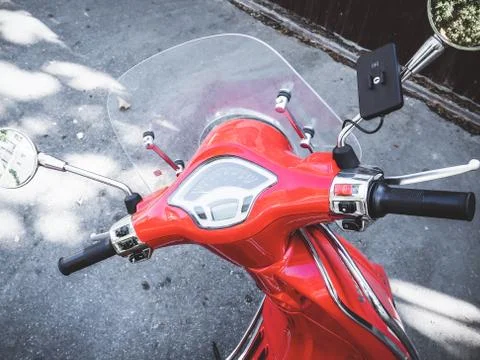 Red glossy motorcycle handlebar with speedometer and choke in the street Stock Photos