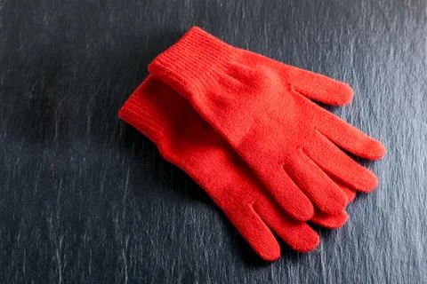 Red gloves on black background Stock Photos