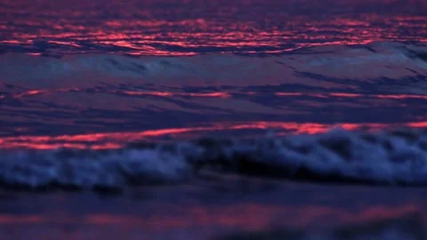 A red glow on the surface of the waves Stock Footage 154191591