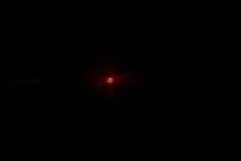 Red glowing celestial body in the deep dark space background with subtle Stock Photos