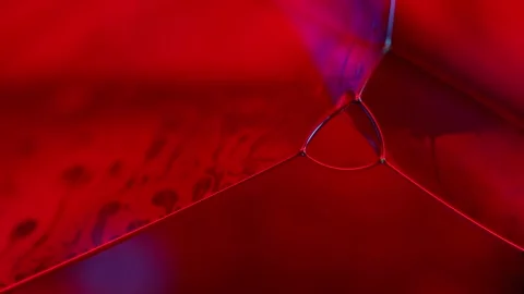 Red glowing reflections of liquid in macro, red liquid surface Stock Footage 319952516