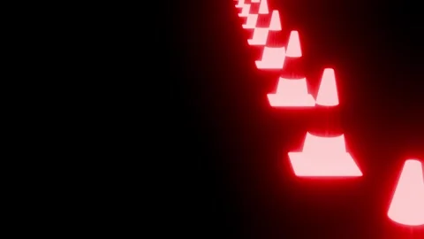 Red glowing traffic cones forming a path on a black background Stock Footage 340646667