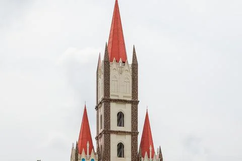 A red gothic steeple church building Stock Photos