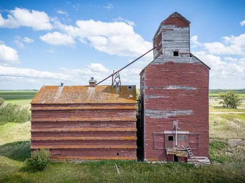 Red grain elevator with a silo in the background Stock Photos
