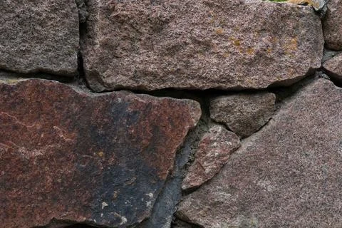 Red granite stone wall texture background with rough natural blocks Stock Photos
