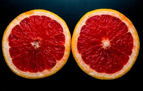 Red grapefruit on black background Stock Photos