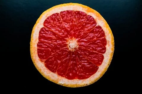 Red grapefruit on black background Stock Photos