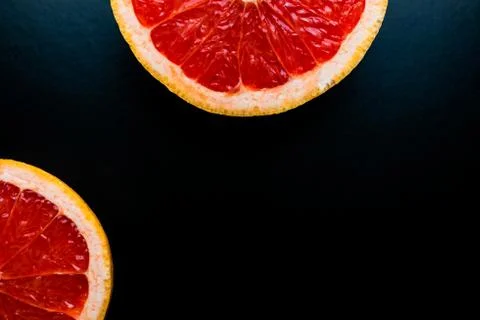 Red grapefruit on black background Stock Photos