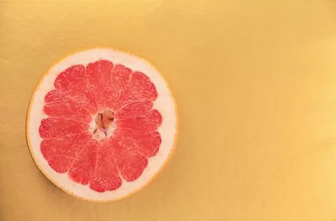 Red grapefruit on a gold background Stock Photos