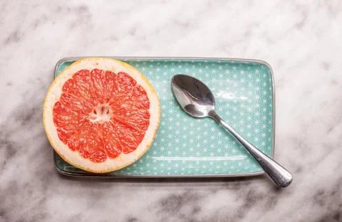 Red grapefruit rectangular plate and spoon Stock Photos