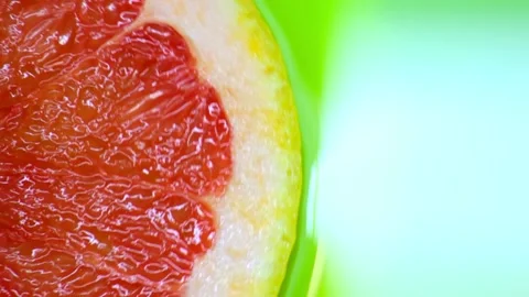 Red grapefruit rotates on a green background copy space Stock Footage 130758627