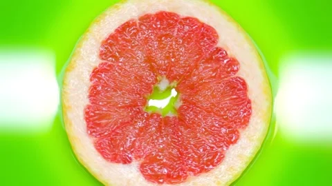 Red grapefruit rotates on a green background copy space Stock Footage 130758660