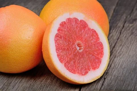 Red grapefruit on rustic wood table Stock Photos