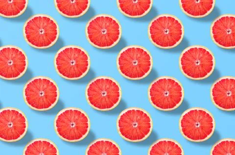 Red grapefruit slice pattern on colorful background Stock Photos