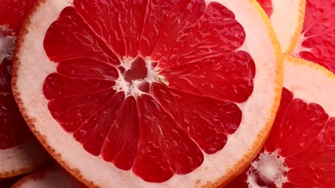 Red grapefruit slices, rotation in circle. Stock Footage 236424552