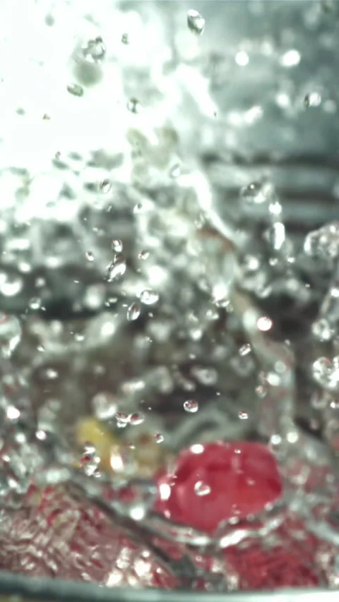 Red grapes fall into a bucket of water. Filmed on a high-speed camera at 1000 Stock Footage 335322077