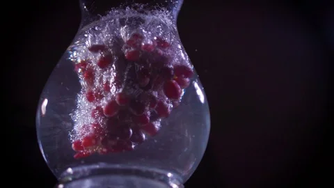 Red grapes fall into water with splashes super slow motion shot Video stock 122982094