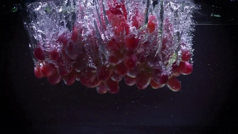 Red grapes fall into water with splashes super slow motion shot Stock Footage 122982167