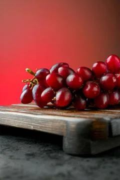 Red grapes on a red background Stock Photos