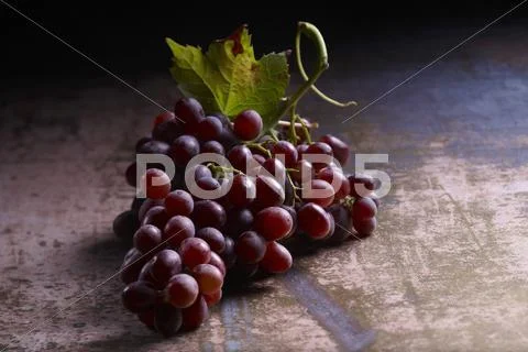 Red Grapes With A Vine Leaf