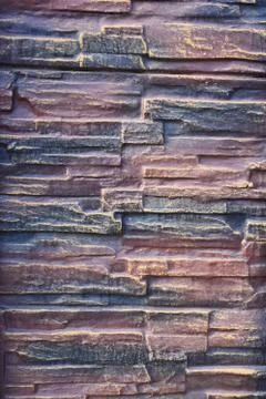 Red-gray torn brick wall. brick background Foto stock