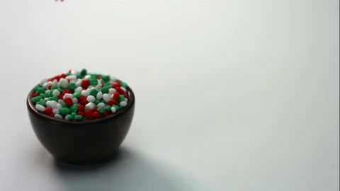 Red Green And White Candy Fall Into Wooden Bowl Stock Footage 70333324