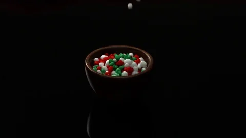 Red Green And White Candy Fall Into Wooden Bowl On Black Background Stock Footage 70333818