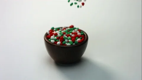 Red Green And White Candy Fall Into Wooden Bowl Stock Footage 70334268