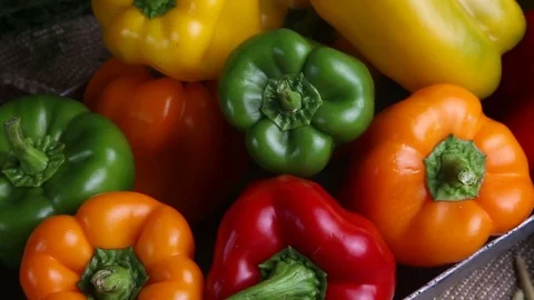Red, green and yellow sweet peppers on a table in a jar in the form of pepper Stock Footage 80754038