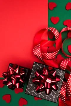 Red-green background with gift boxes with geometric pattern. Stock Photos