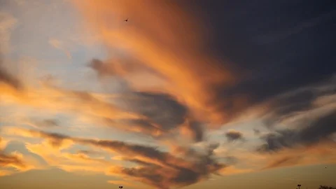 Red grey and orange clouds and birds flying around Stock Footage 87647018