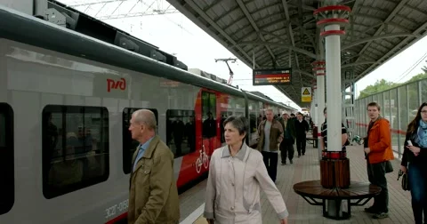 Red grey the train stops at the platform, doors are closed, passengers go Stock Footage 67469739